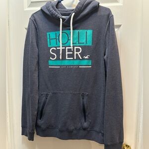 Hollister Men's Dark Navy Pullover Hoodie with Teal Logo